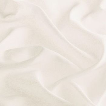 A soft off-white fabric sheet with gentle folds and shallow depressions; rumpled and draped, creating subtle shadows — close-up under diffuse, warm lighting against a neutral background.