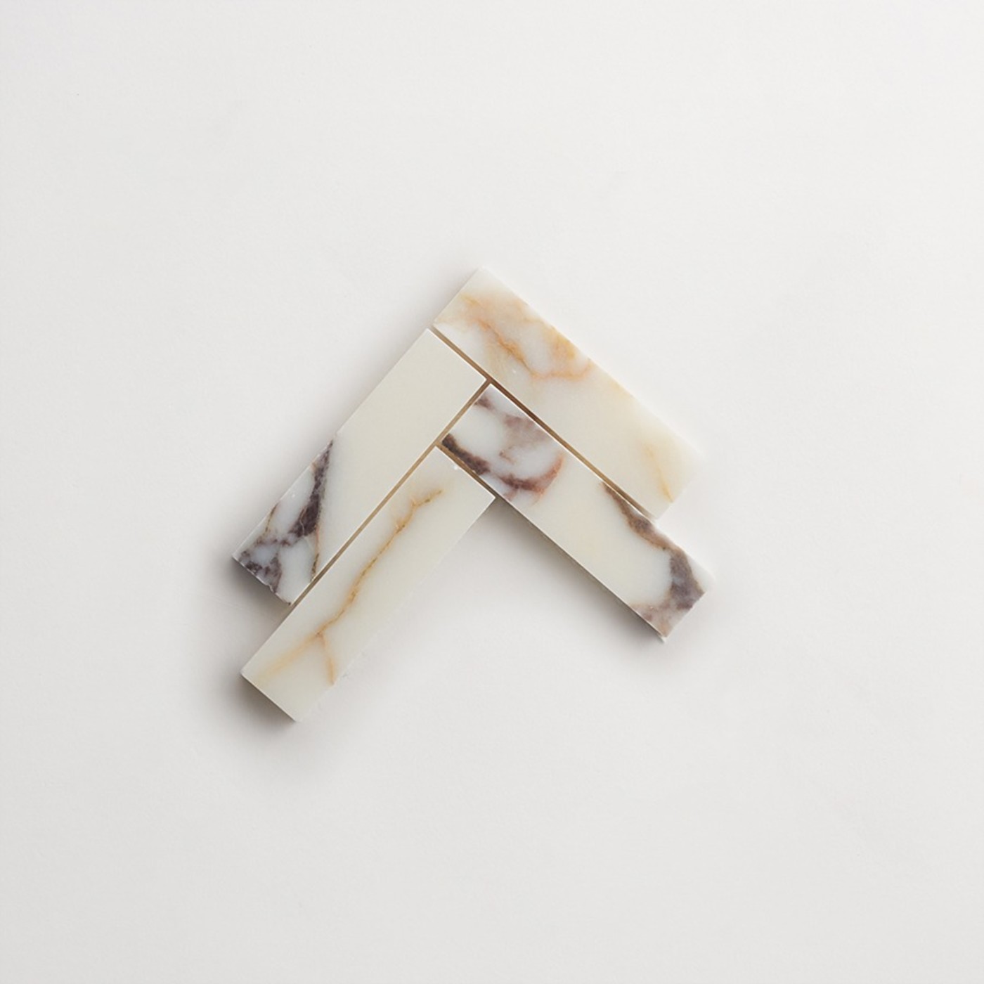 marble tiles in a chevron pattern on a white surface.