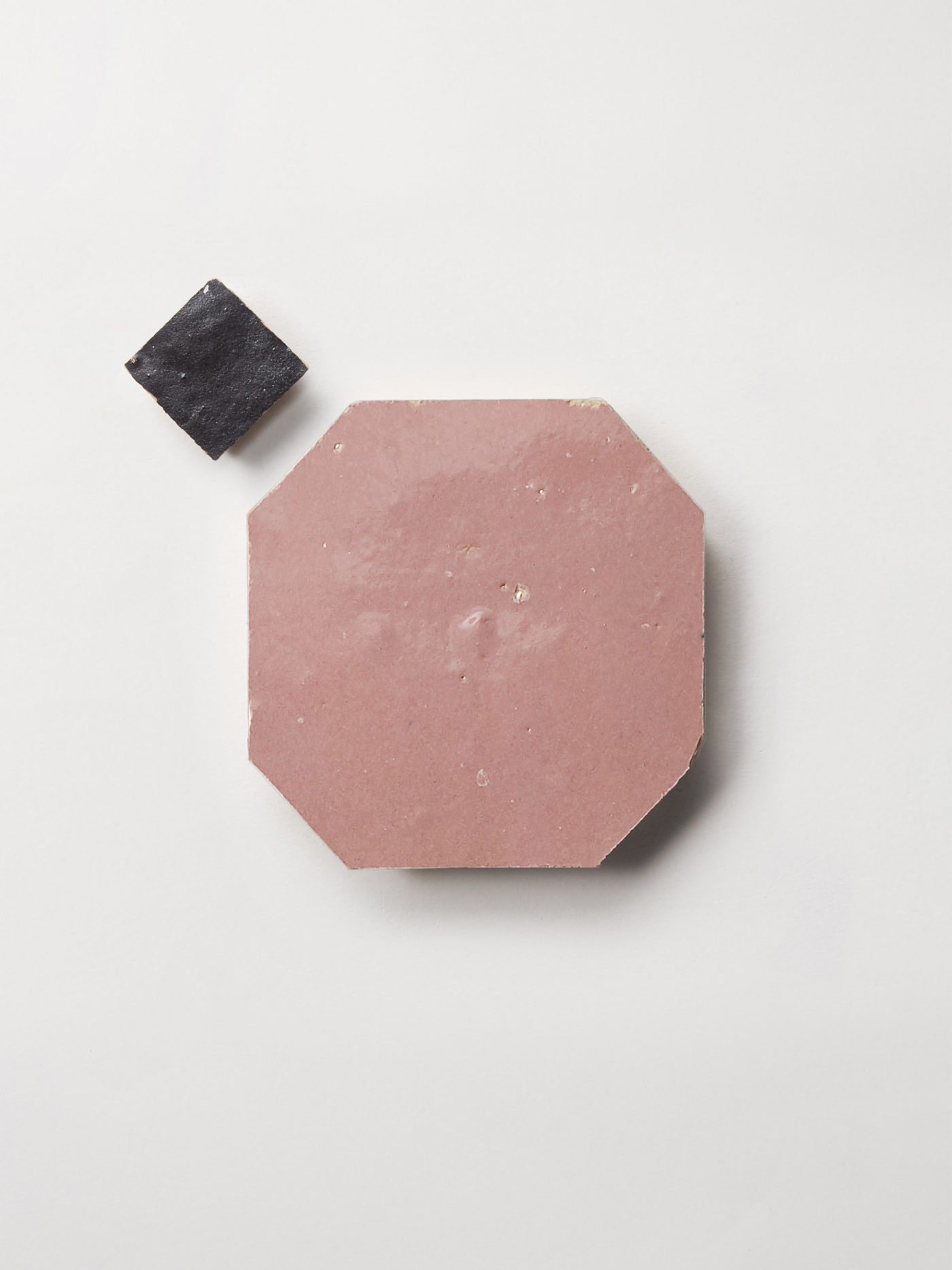 pink and black tiles on a white surface.