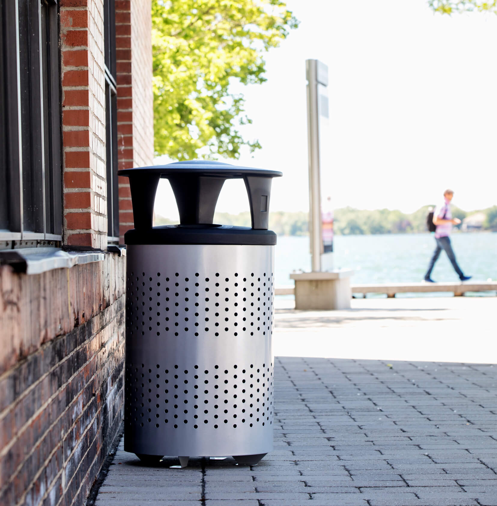 silver and black outdoor durable trash bin with a canopy lid to keep rain and snow from contaminating contents