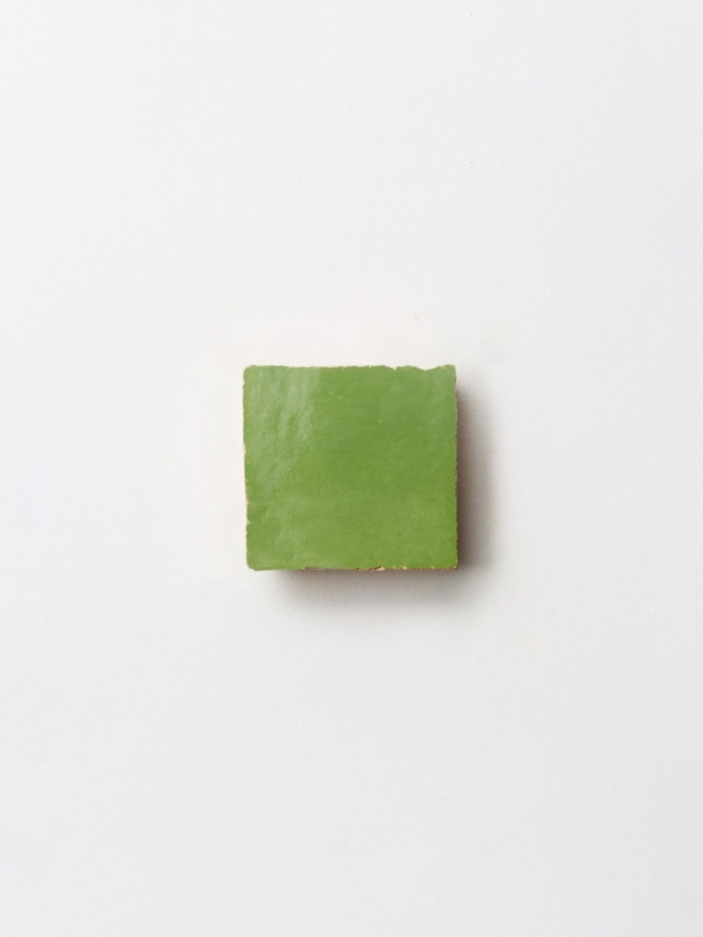 a green square tile on a white background.