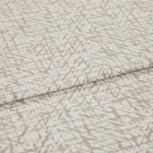 Textured beige-and-white fabric with an abstract, twiglike pattern, folded and layered once; close-up on a flat surface with soft, even lighting, suggesting a fabric sample or upholstery swatch.