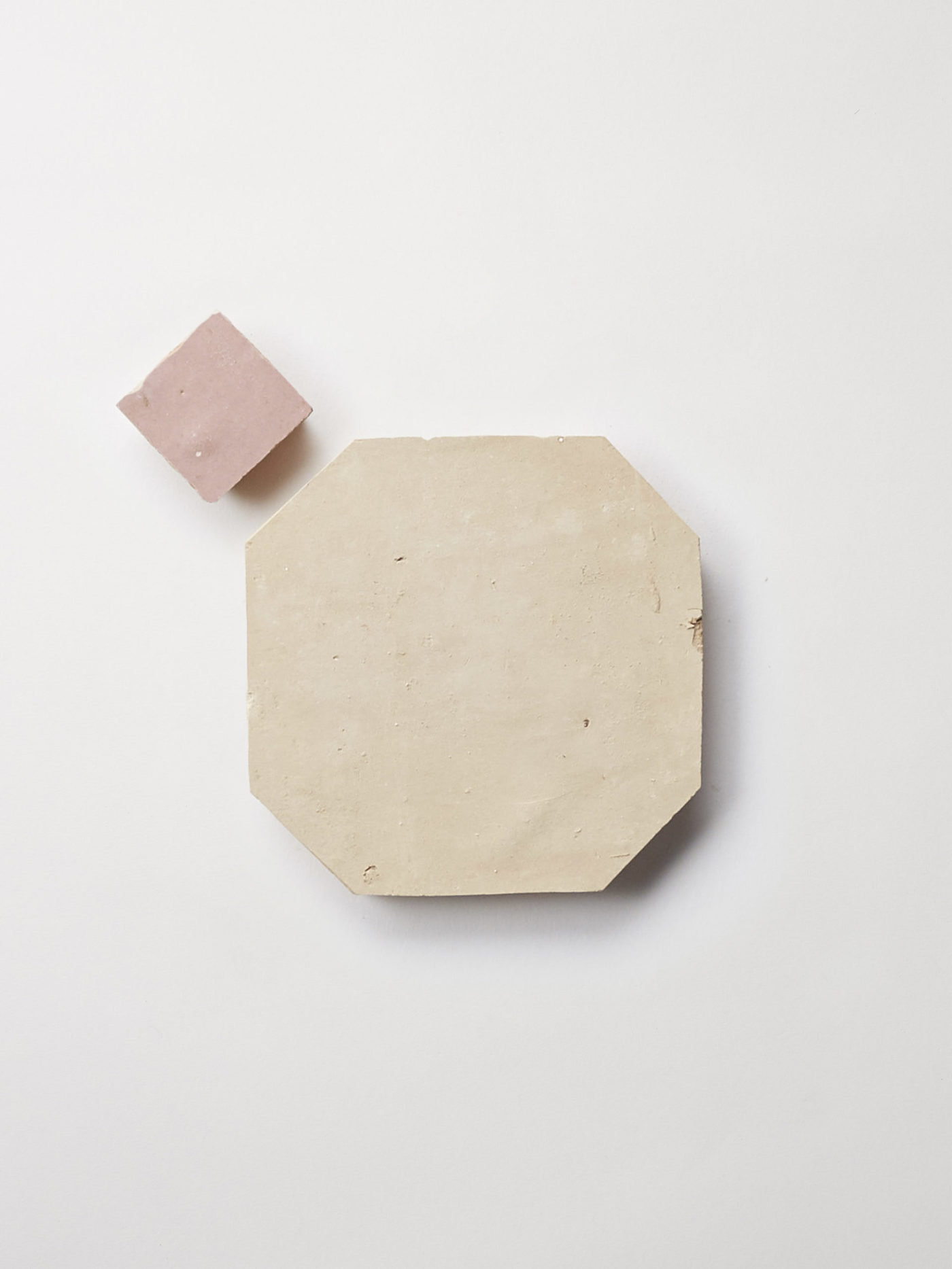 a pink and white piece of paper on a white surface.