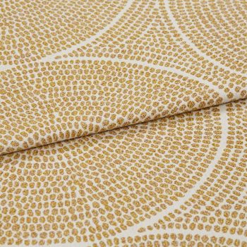Cream woven fabric with raised golden-dot concentric pattern, folded and slightly overlapped, shown in a close-up with soft, even lighting and shallow depth of field.