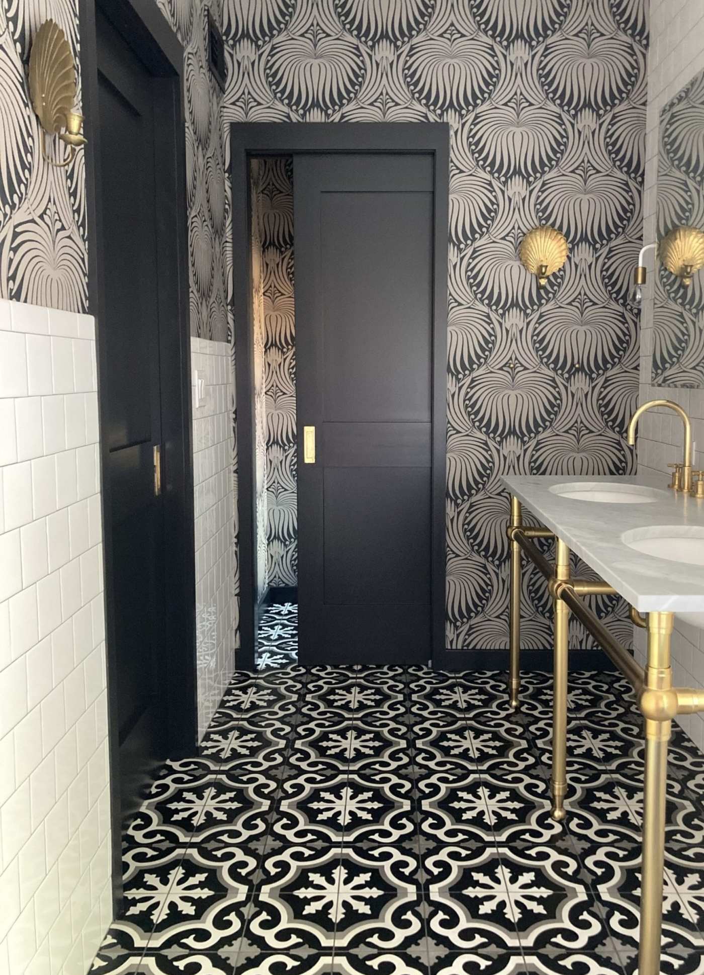 a bathroom with a black and white tiled floor.