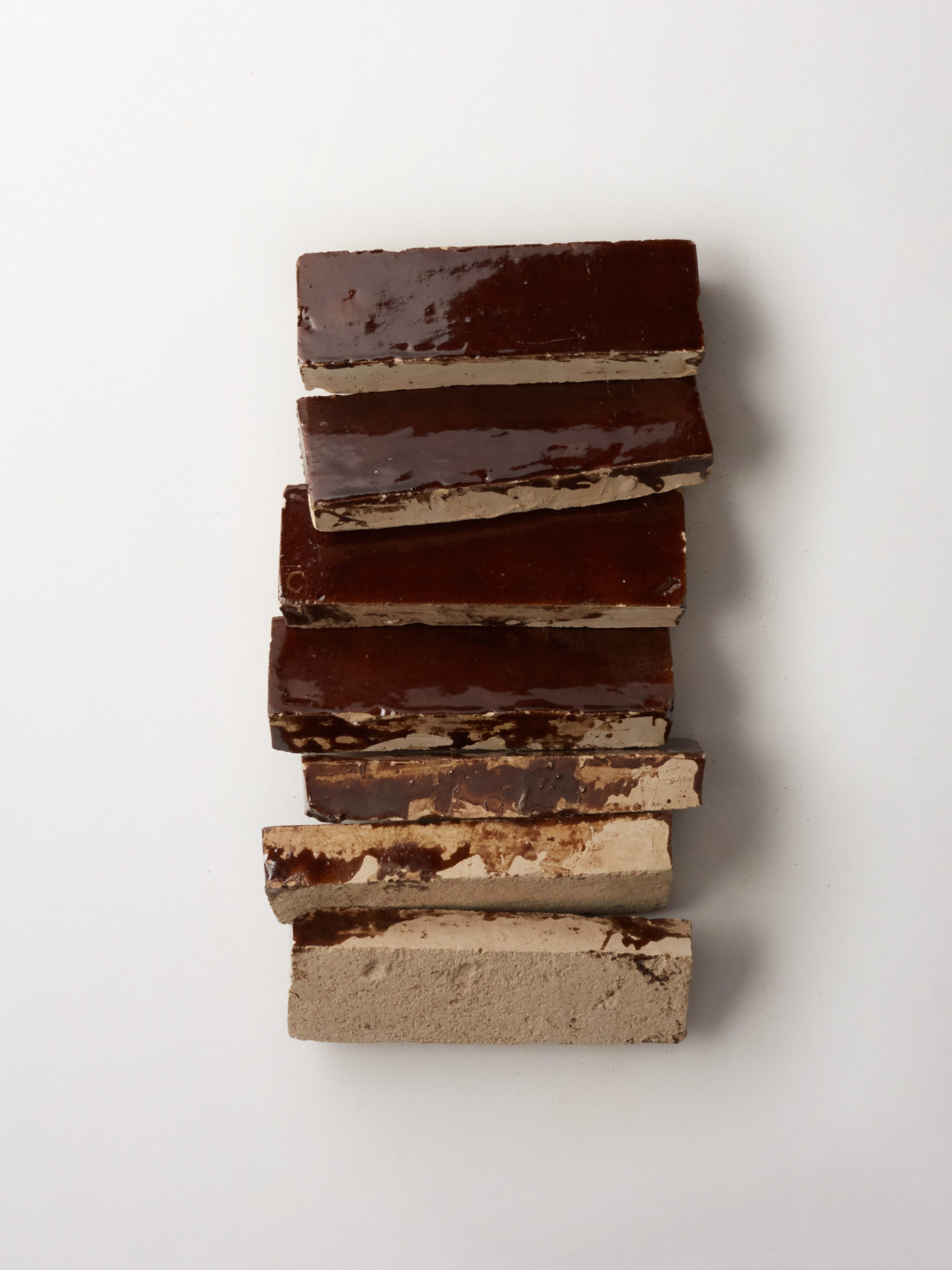 a stack of brown tiles on a white background.