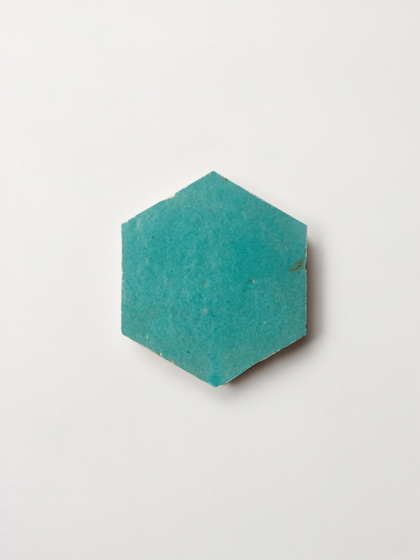 a turquoise hexagonal tile on a white background.