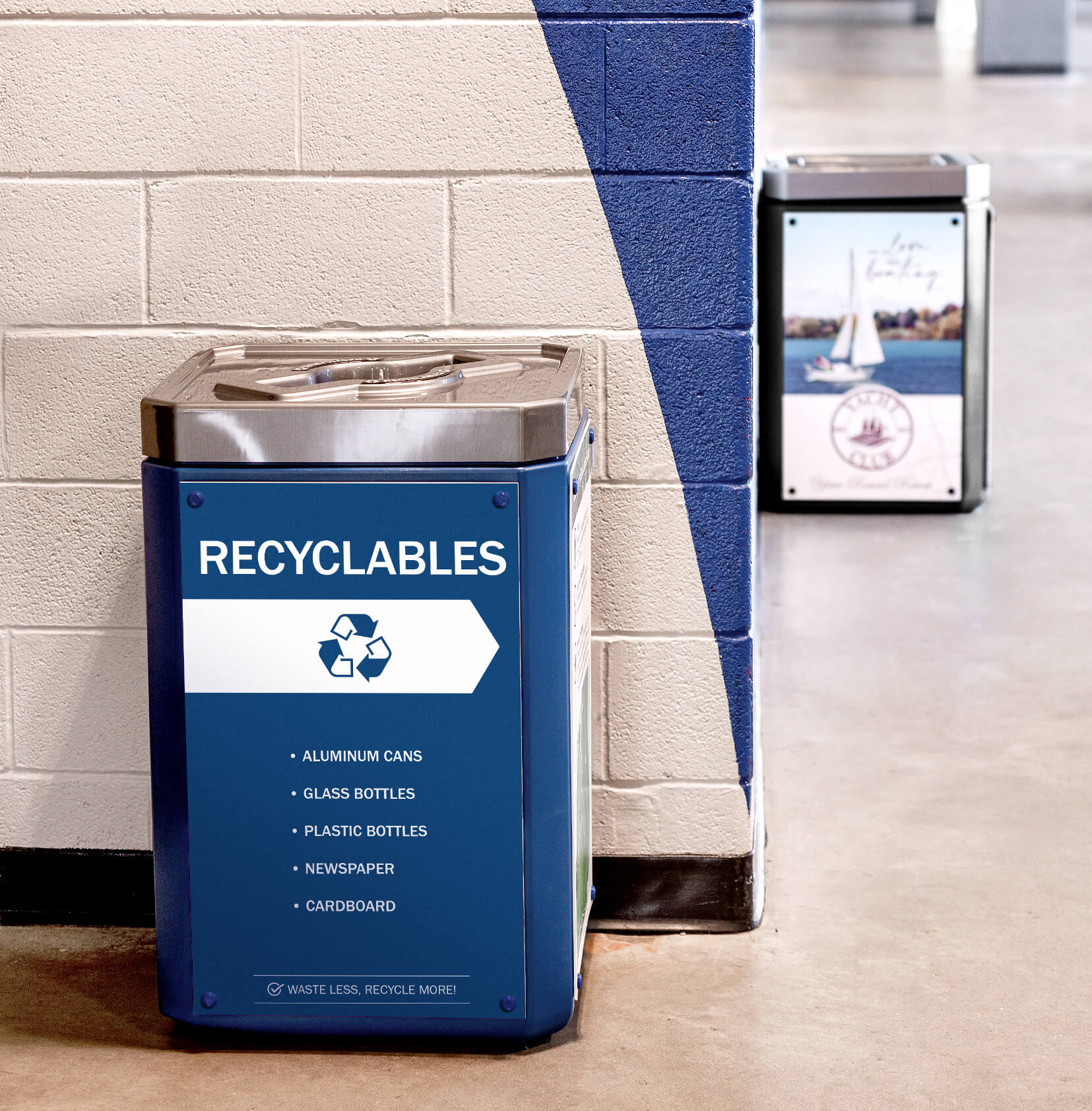 blue recycling container with mixed opening lid including a large body sign in an arena hallway