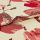 Cream jacquard fabric with large red floral motifs, folded once so layers overlap; embroidered sheen and textured stitching visible in a close-up, studio-lit product shot.