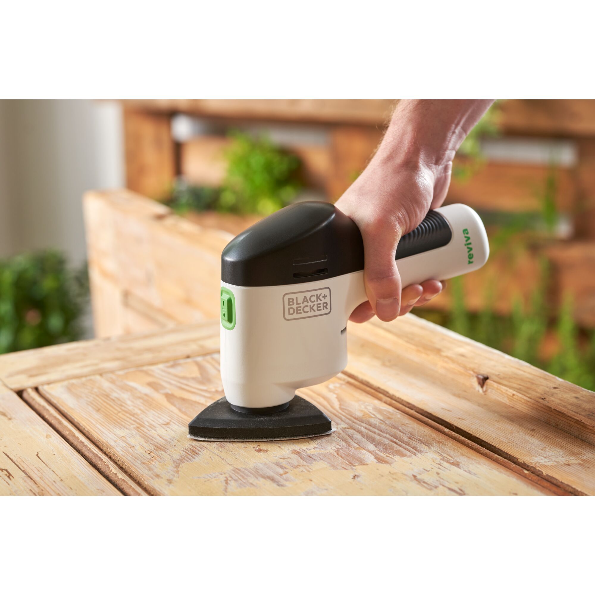 reviva™ 12V MAX* Cordless Detail Sander being used to sand a cabinet door.