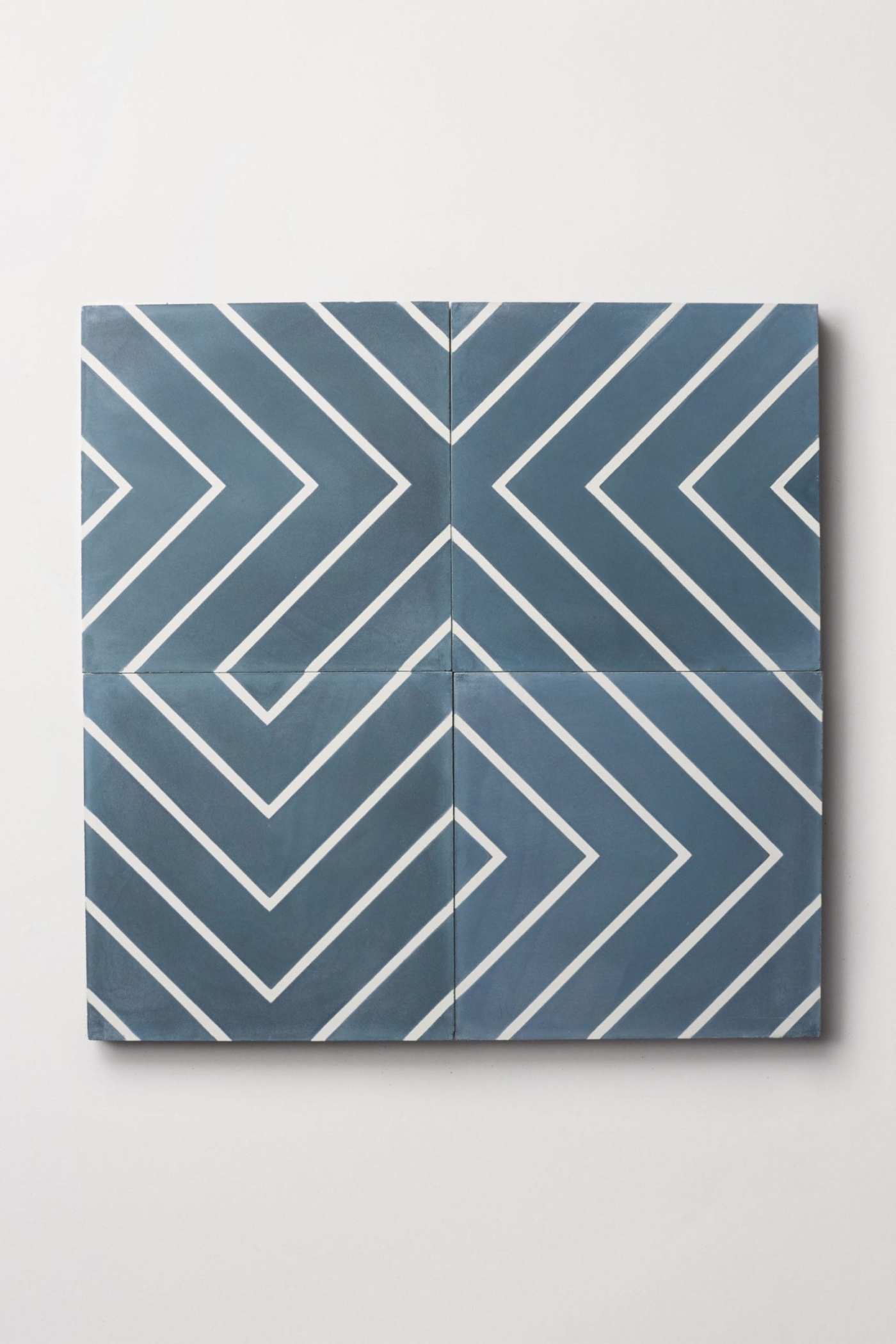 four blue and white tiles forming a chevron pattern.