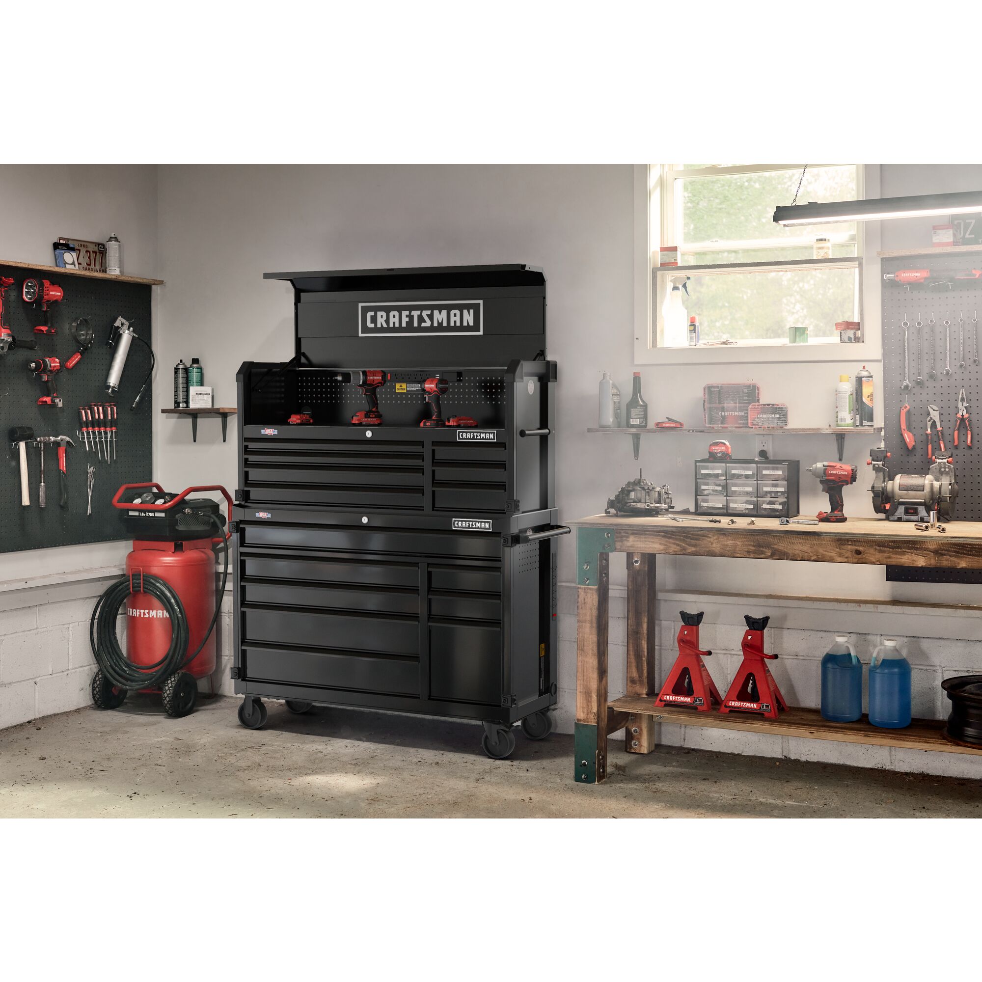 Black CRAFTSMAN Premium S2000 Series 52-inch wide Metal Tool Storage Cabinet and chest stacked on top of each other in a residential garage setting, surrounded by other CRAFTSMAN tools.