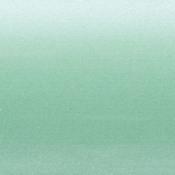 Textured frosted glass panel showing a soft horizontal green gradient from pale mint to deeper seafoam, speckled grain—uniformly lit close-up, no visible frame or surroundings.