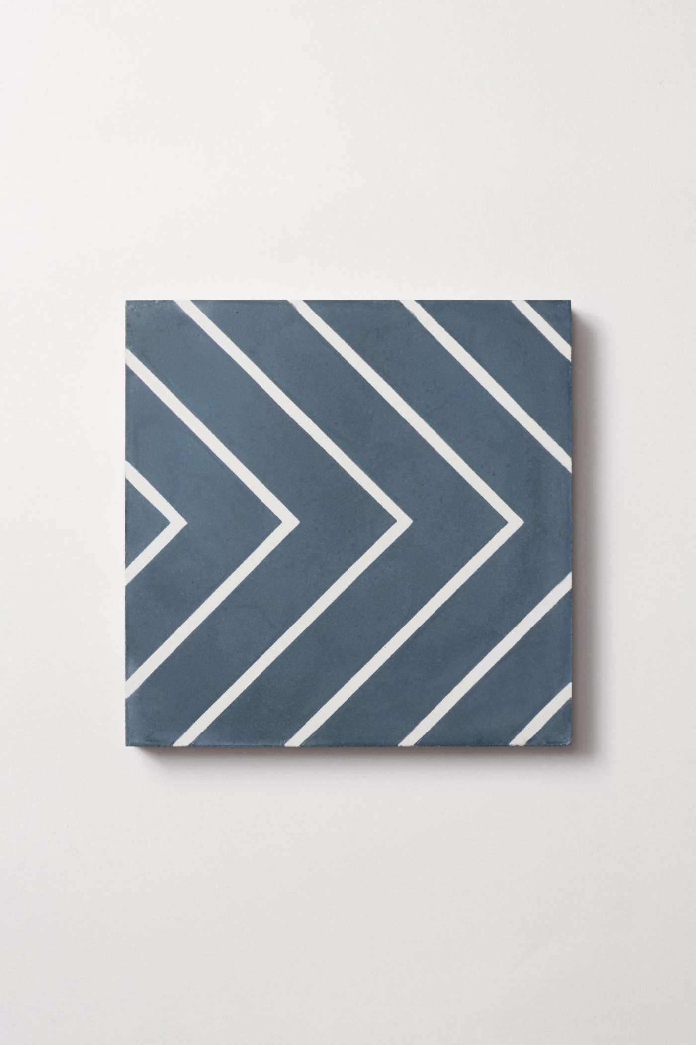 a blue and white tile with a chevron pattern.