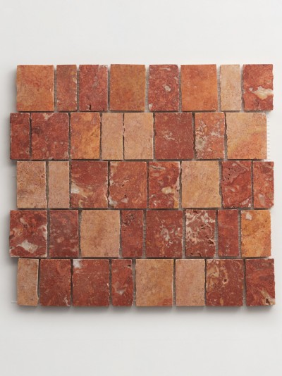 a red and brown marble tile on a white surface.