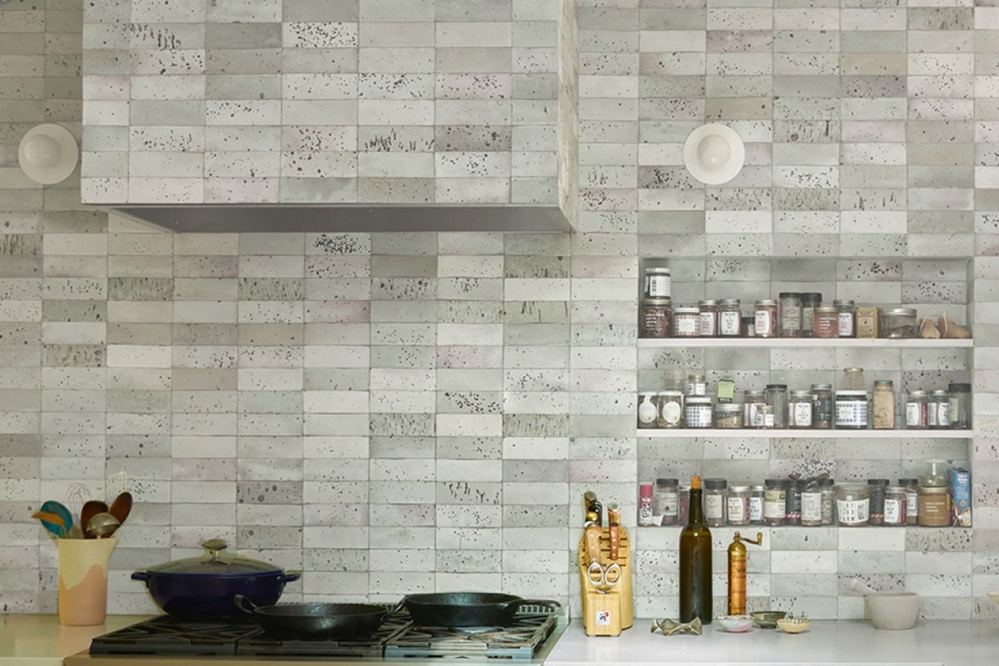 a kitchen with a tiled backsplash and a stove.