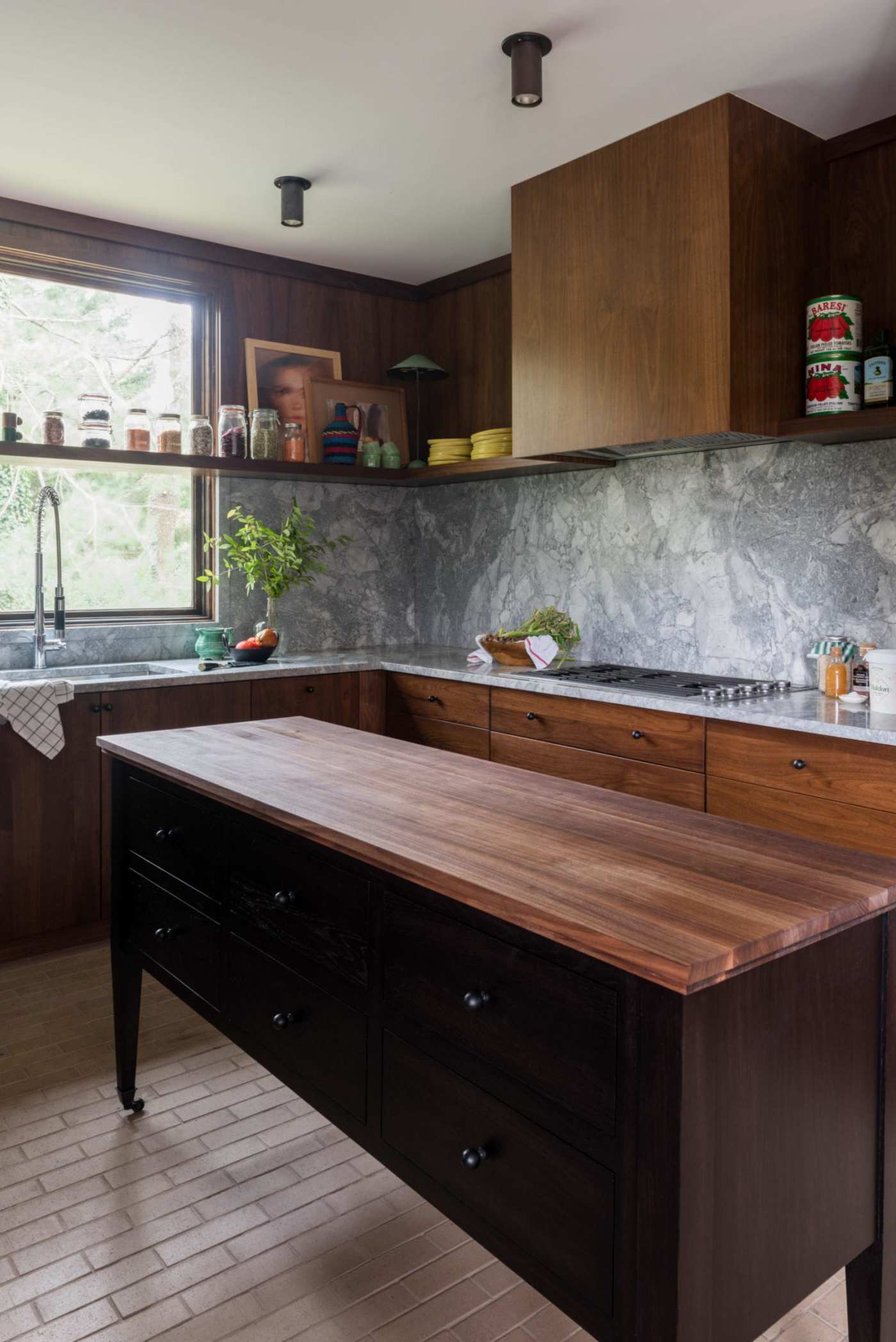 a kitchen with wood cabinets and a wooden island.