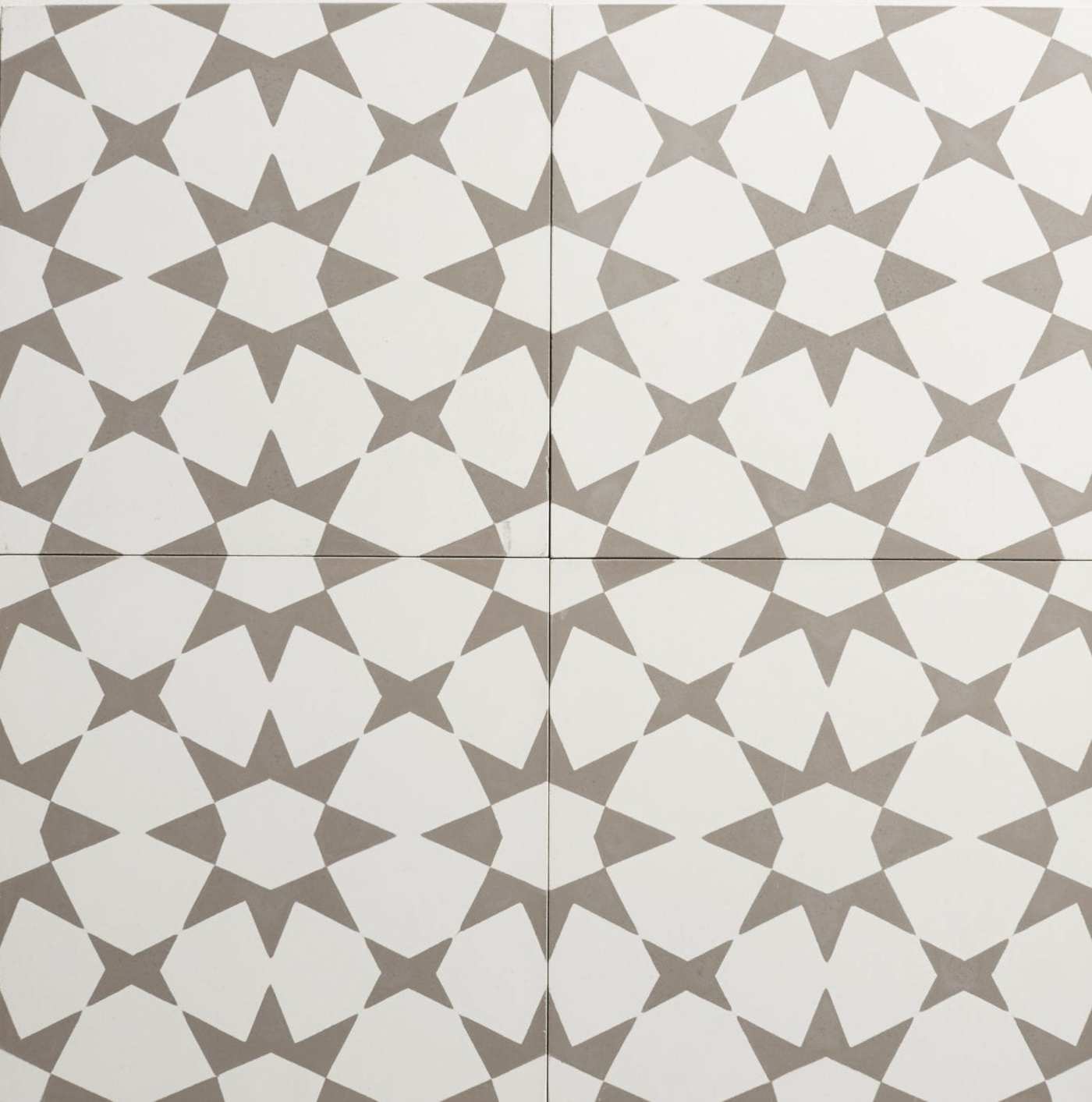 four white and grey tiles with geometric designs.