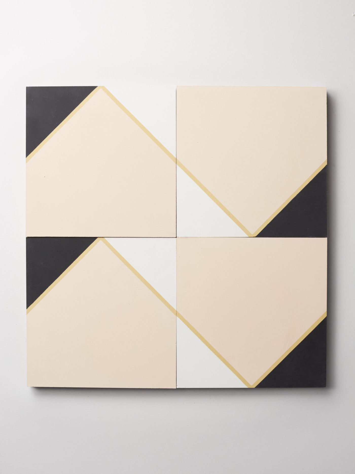 four tiles with black and white geometric shape designs on a white background.