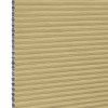 Honeycomb (cellular) blind, tan with silver inner cells, fully lowered and closed, filtering and blocking light; close-up view showing horizontal pleats and cell edges against a neutral interior background.