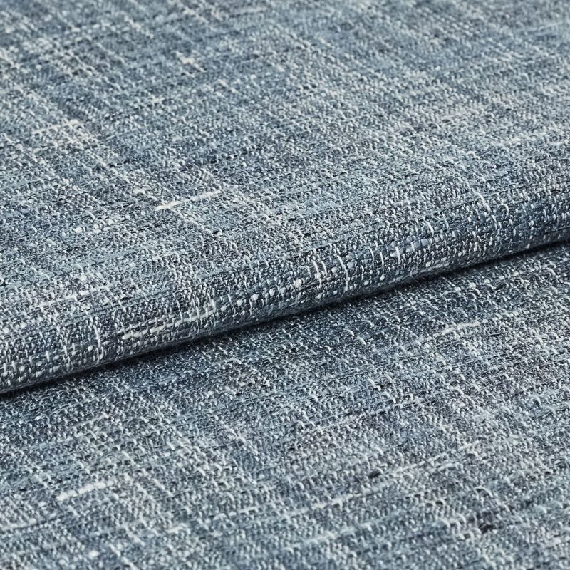 Blue-gray woven fabric swatch with irregular white flecks â€” folded and overlapped â€” close-up studio view with even lighting, emphasizing coarse looped weave and subtle color variation.