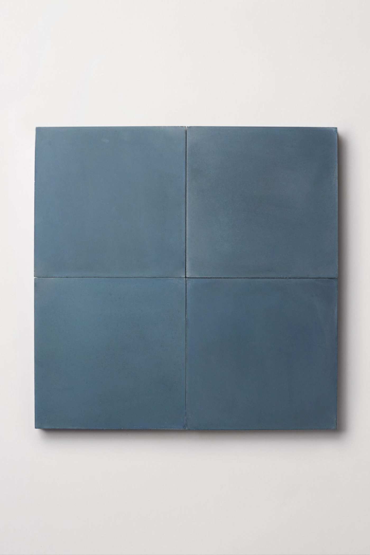 four square blue tiles on a white background.