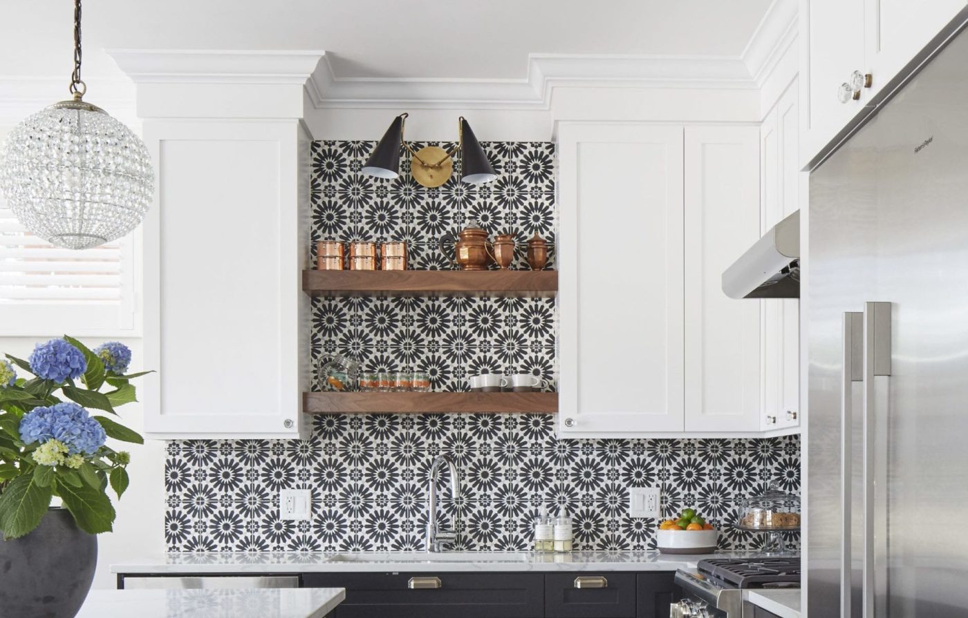 a kitchen with a black and white tile backsplash.