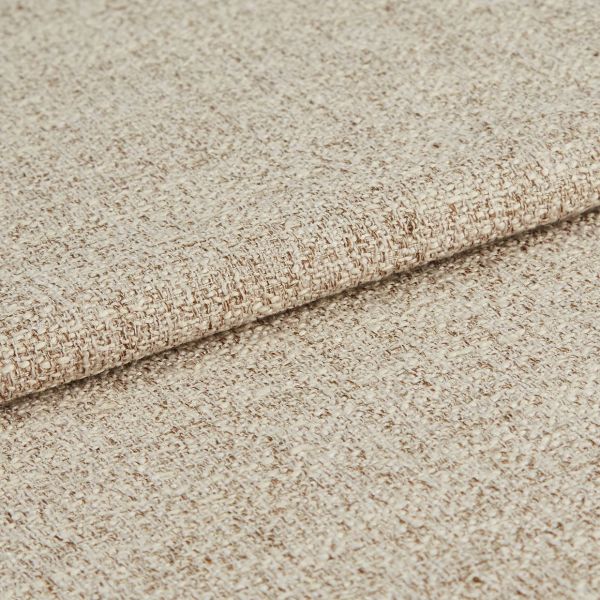 Beige woven upholstery fabric, densely textured and folded once; showing looped weave and subtle two-tone yarns, close-up on a neutral background under soft, even lighting.