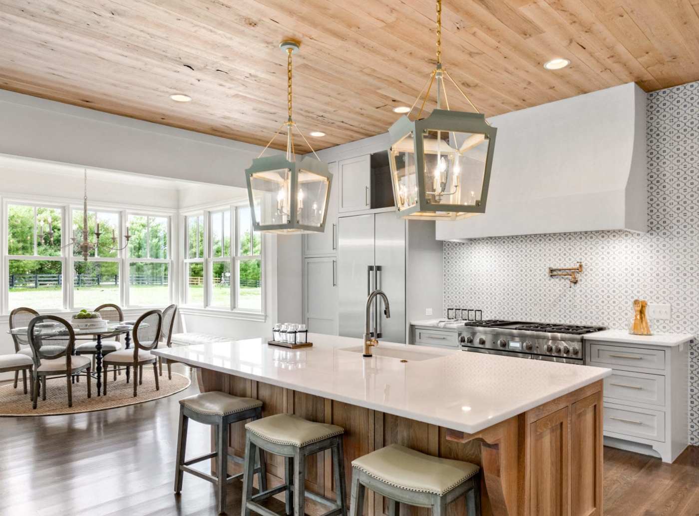 a kitchen with wood ceilings and a center island.