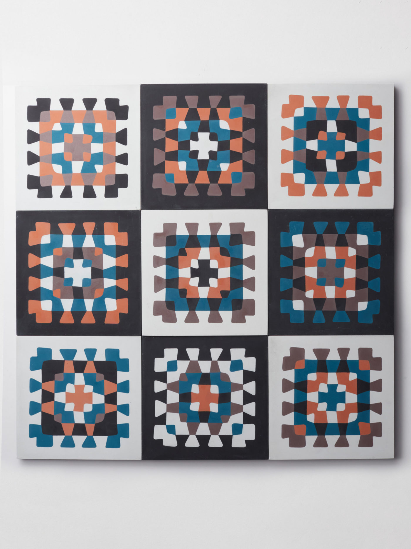 nine tiles with a blue, orange, and brown crochet patterns on them.