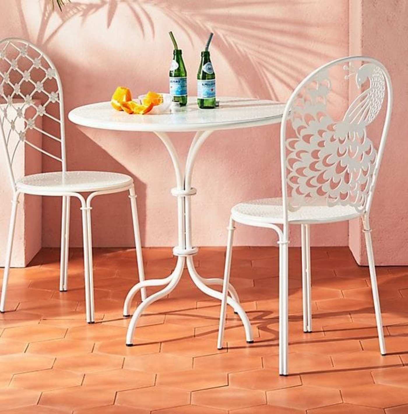 a white table and chairs on an orange tiled floor.