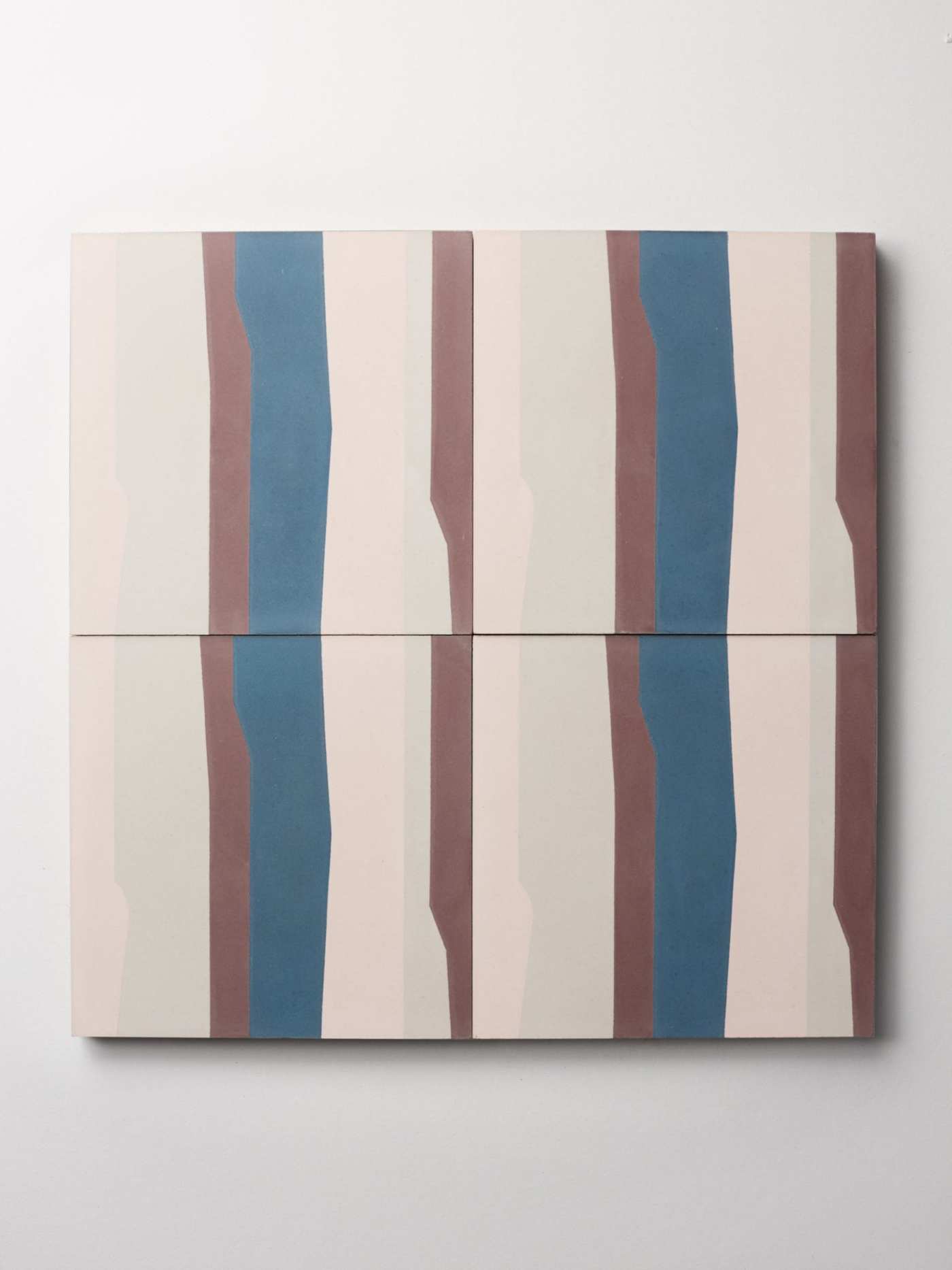 four blue, brown, and white tiles on a white surface.