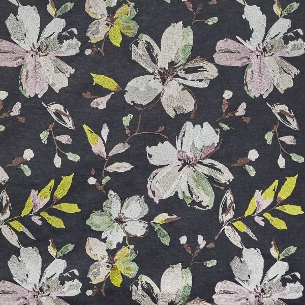 Dark charcoal textile featuring embroidered pastel floral motifs—large, sketchy blossoms and leaves—repeating across the surface, creating a soft, vintage botanical pattern in muted pinks, greens, and yellow.