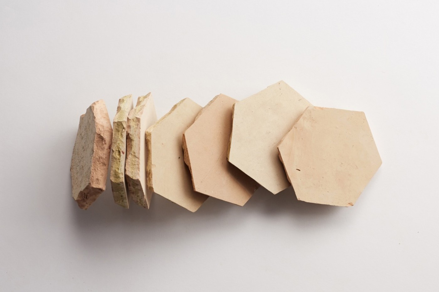 a group of clay hex tiles on a white background.