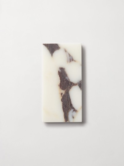 a white and brown soap bar on a white surface.