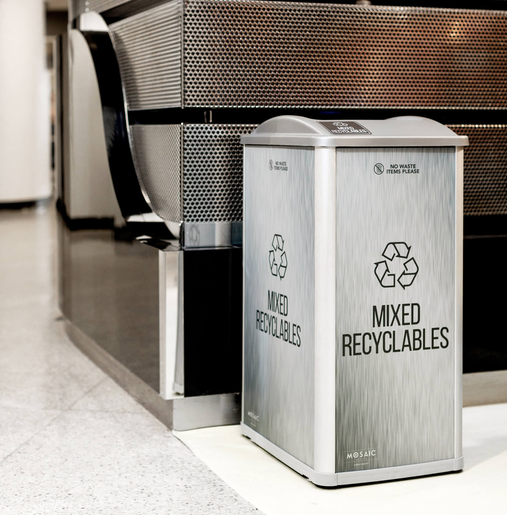 mixed recyclables container in an automotive showroom with signage