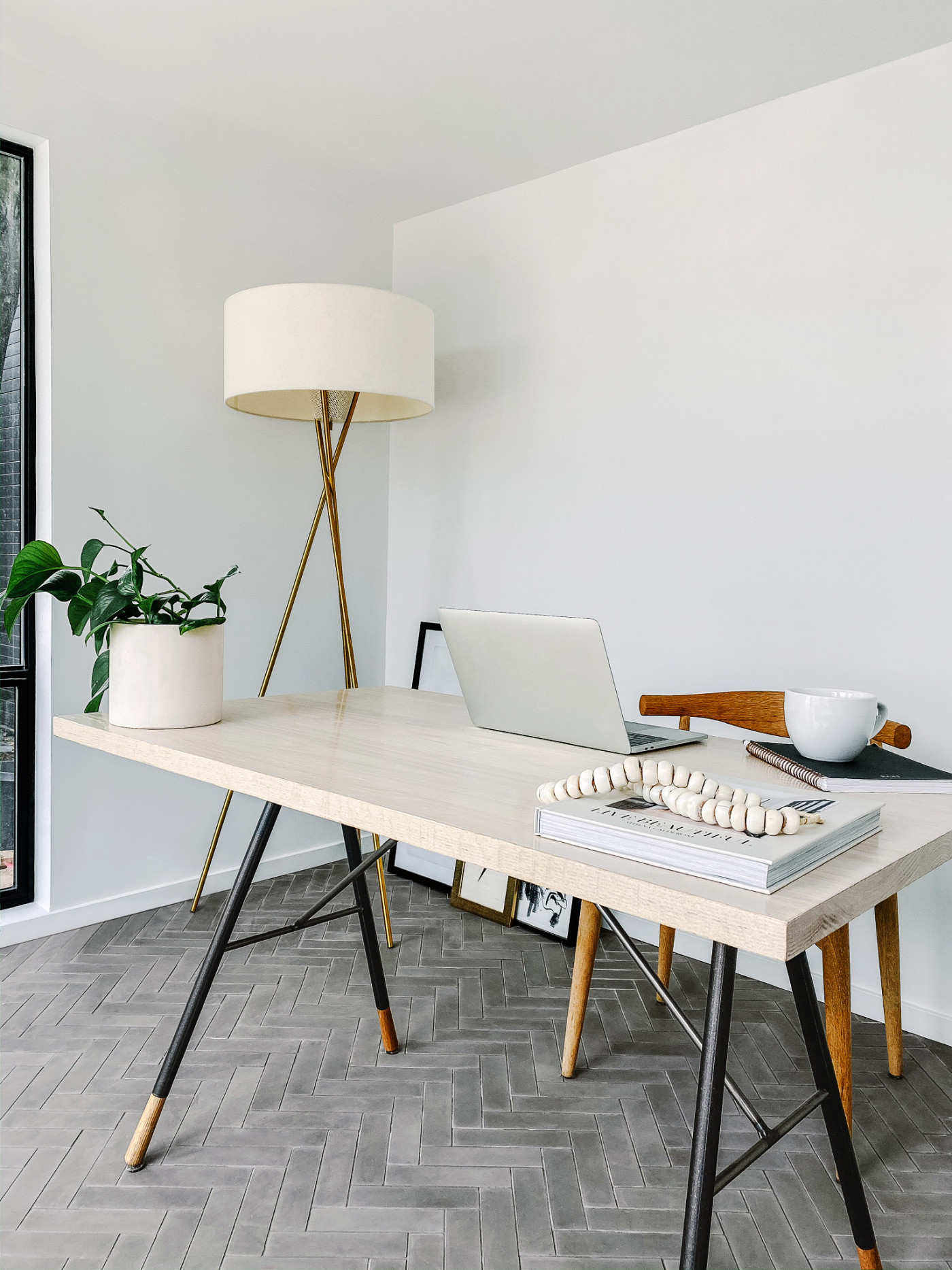 a modern home office with a wooden table and a lamp.