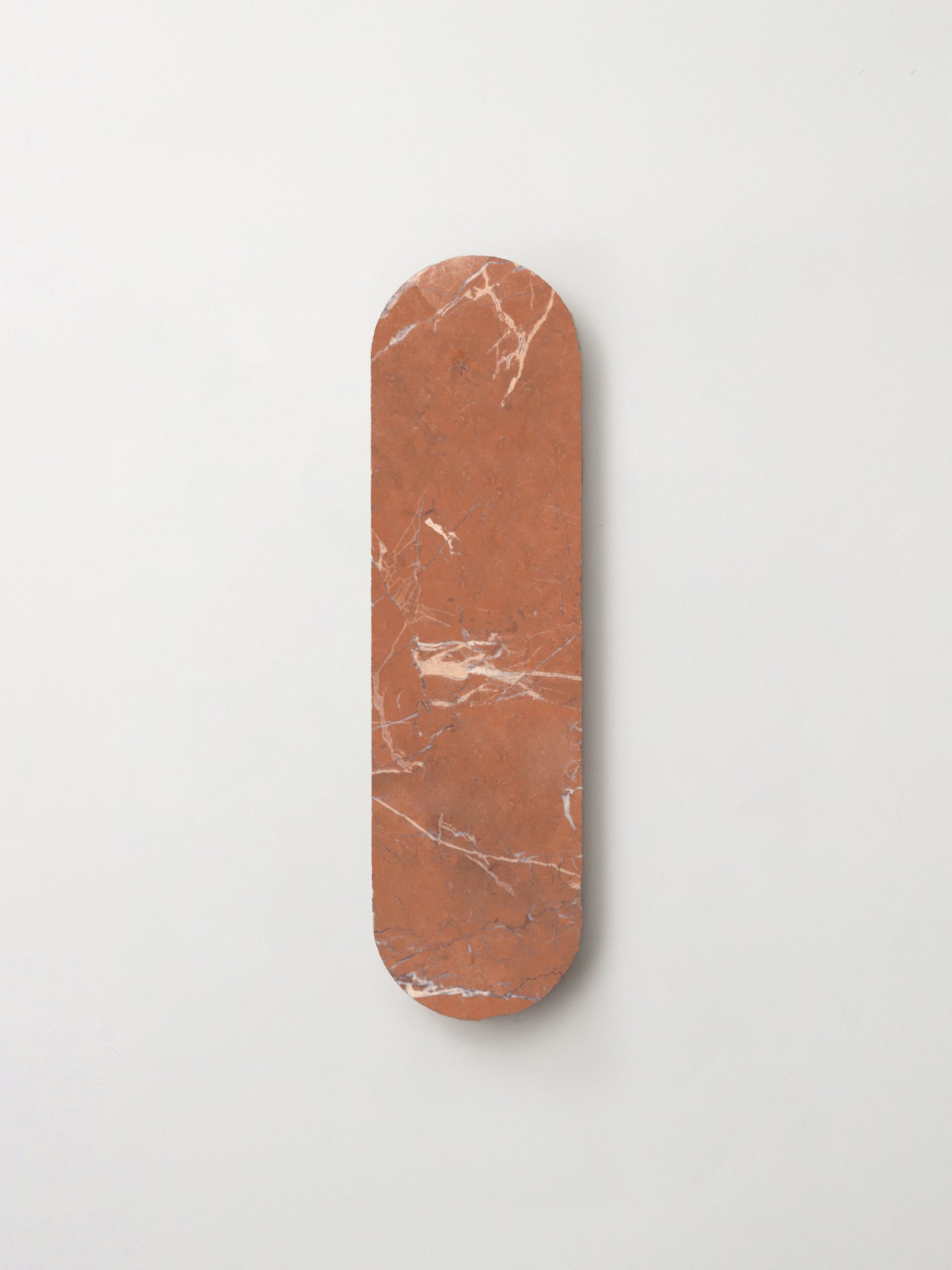 a piece of oval, red natural stone tile on a white surface.