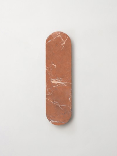 an orange marble skateboard on a white surface.