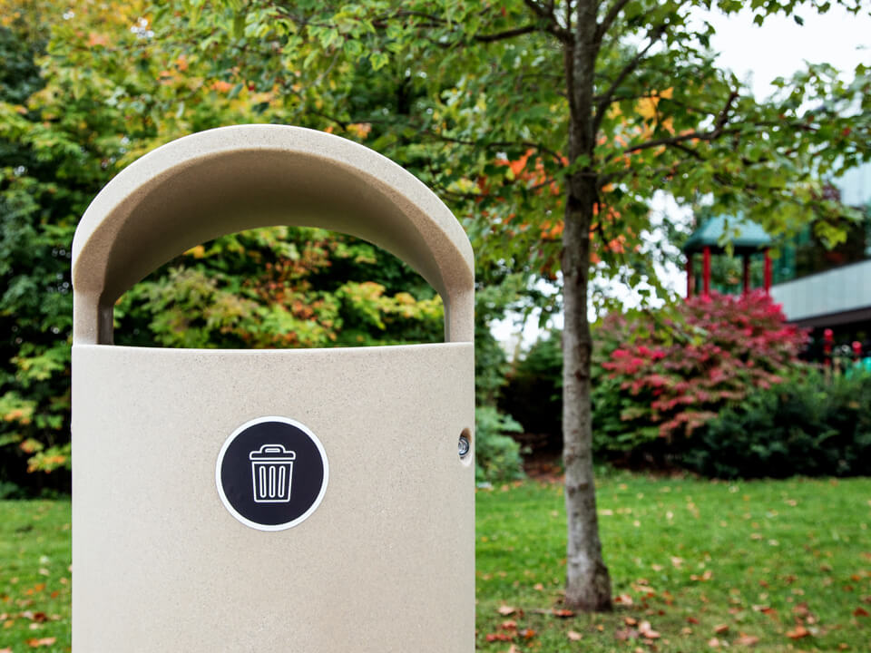 beige waste bin with canopy lid outdoors at community park