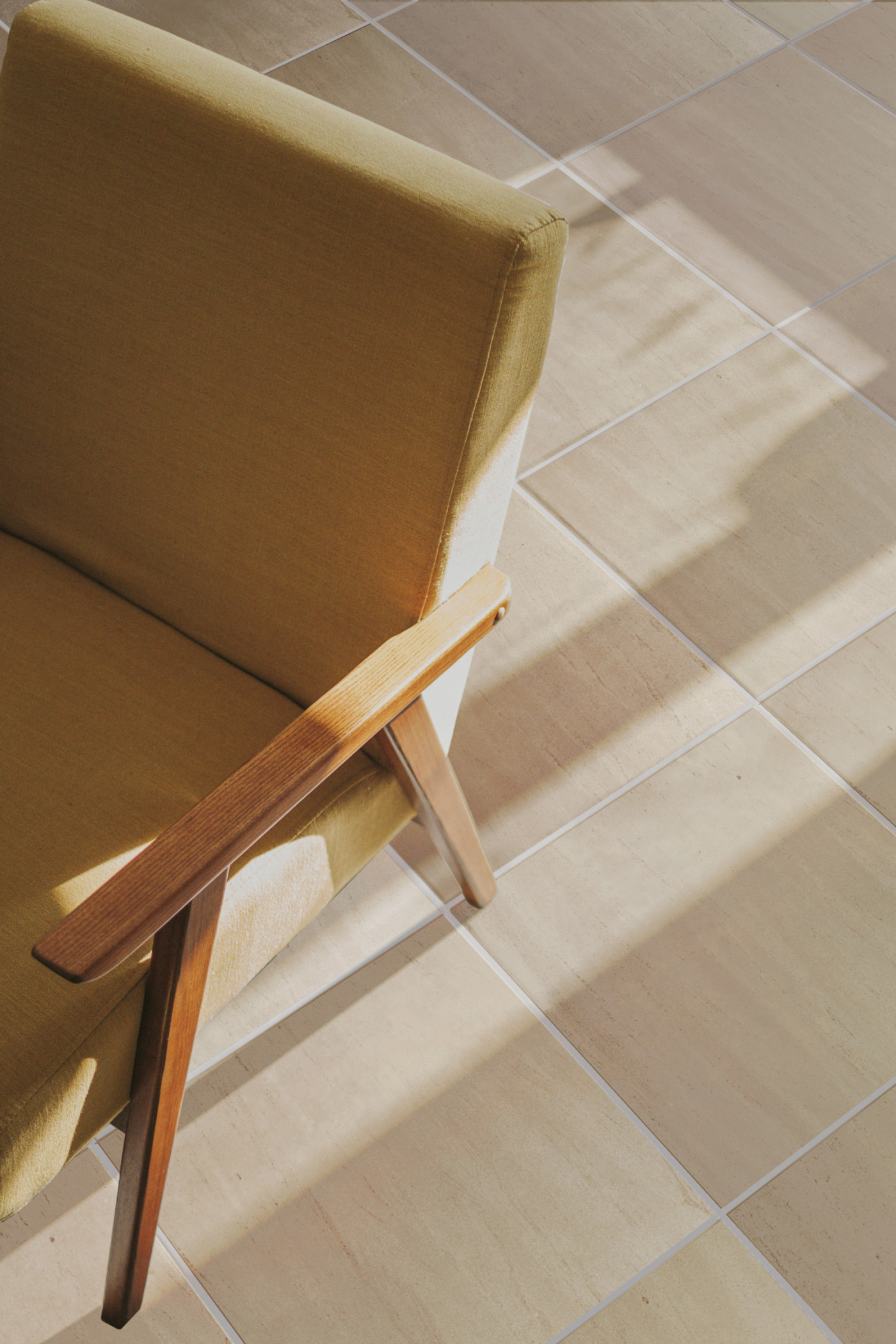 a wooden chair on a tiled floor.