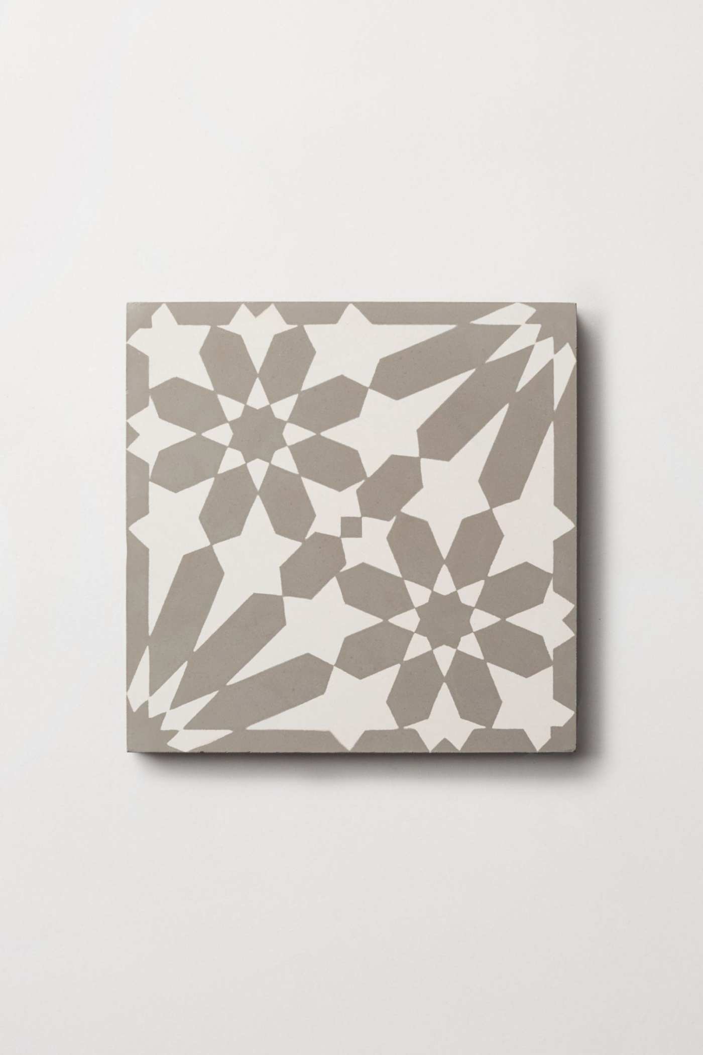 a grey and white tile on a white surface.