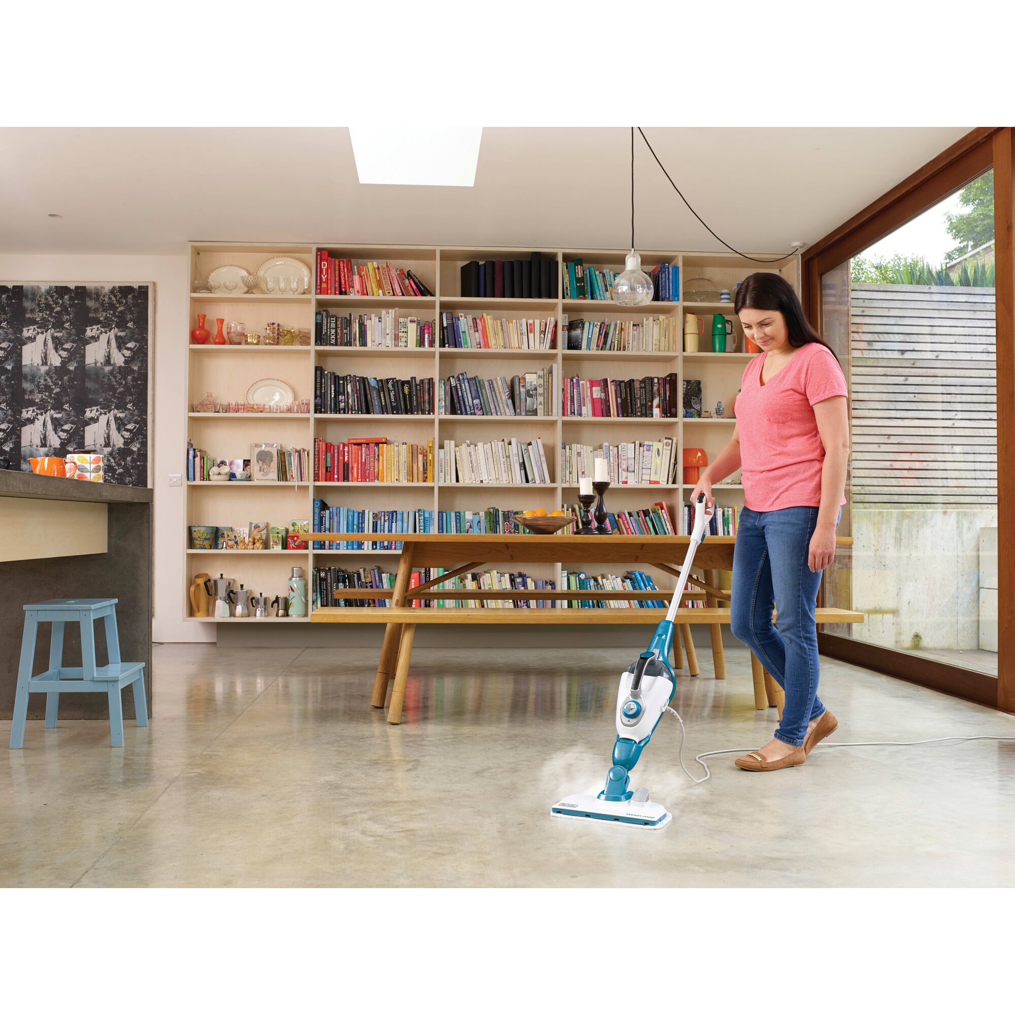 7 in 1 steam mop with steamglove handheld steamer be in g used to steam the floor by a person in a room.