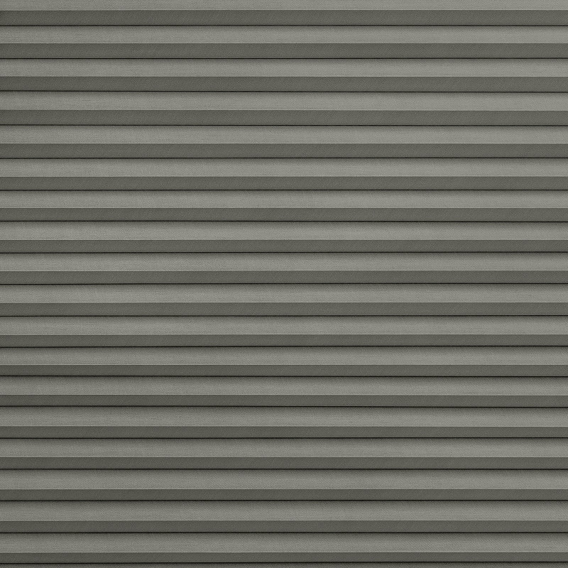Gray horizontal pleated fabric blinds, fully lowered and tightly closed, blocking light; occupy the entire frame against a neutral interior wall, creating uniform textured shading and soft, even ambient light.