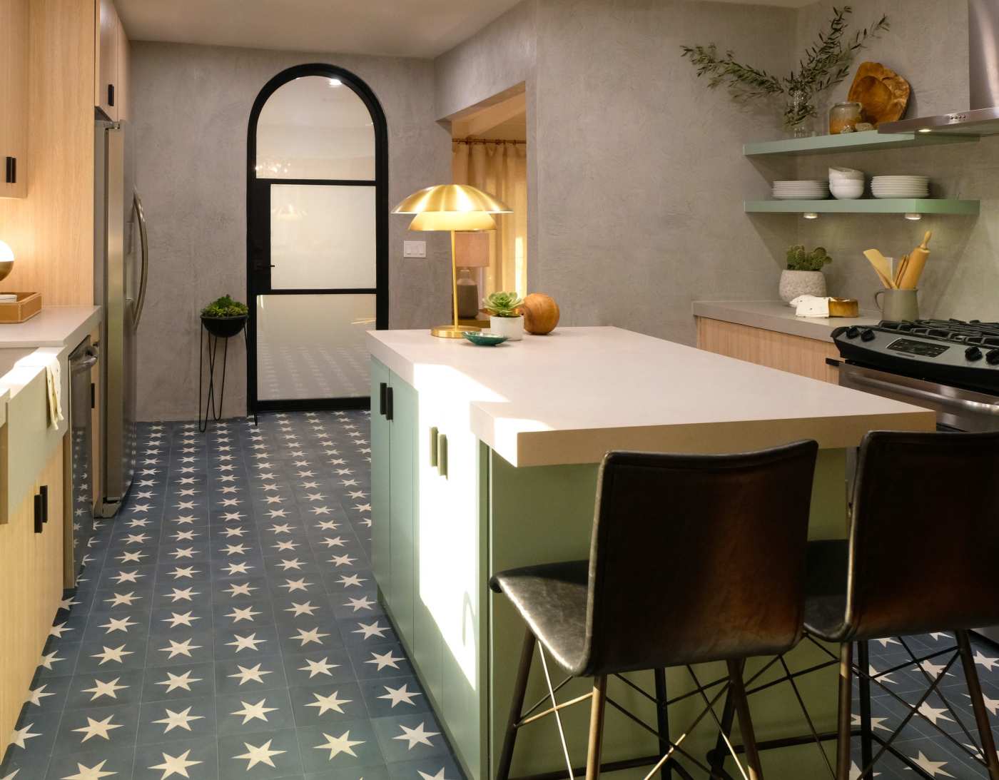 a kitchen with a blue and white tiled floor with star designs.