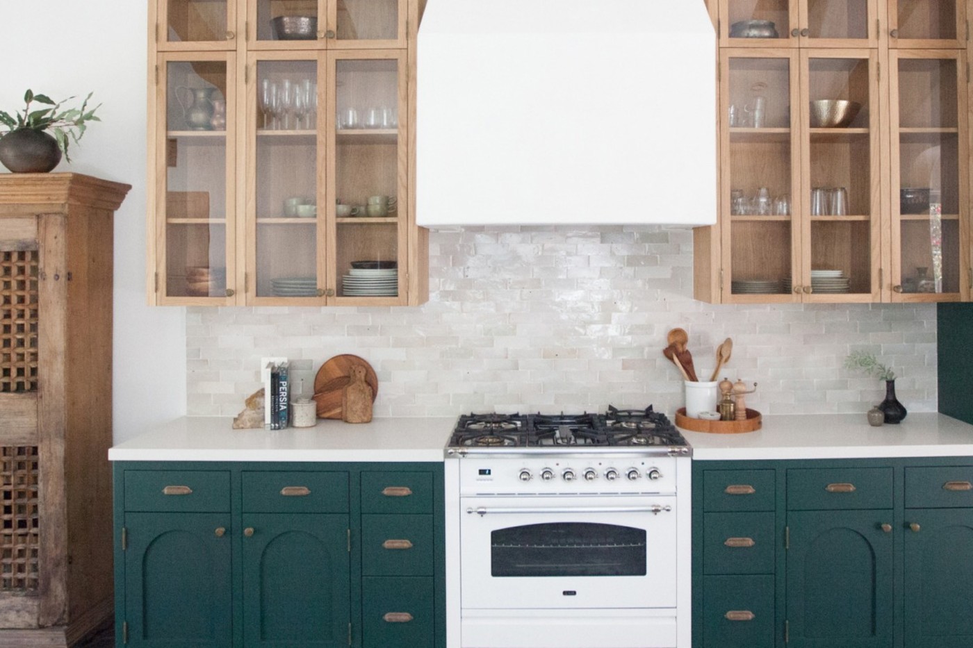 a kitchen with white counters and wooden cabinets.