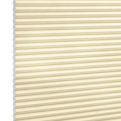 Beige honeycomb (cellular) blinds, fully lowered and closed, filtering soft light; exposed left edge shows hexagonal cell ends against a plain white background.