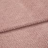Textured woven upholstery fabric, dusty rose with small creamy fleck pattern, folded in two layers; lying flat on a neutral surface under soft, diffuse studio lighting for detail display.