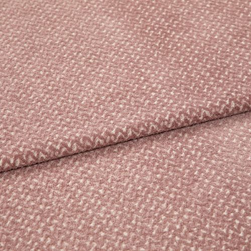 Textured woven upholstery fabric, dusty rose with small creamy fleck pattern, folded in two layers; lying flat on a neutral surface under soft, diffuse studio lighting for detail display.