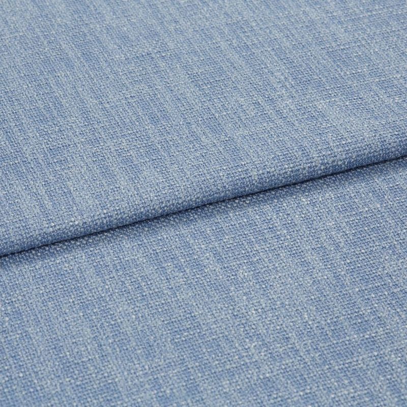 Blue woven upholstery fabric folded across the frame, showing a horizontal overlap and nubby textured weave; close-up shot with soft, even studio lighting and no background details.